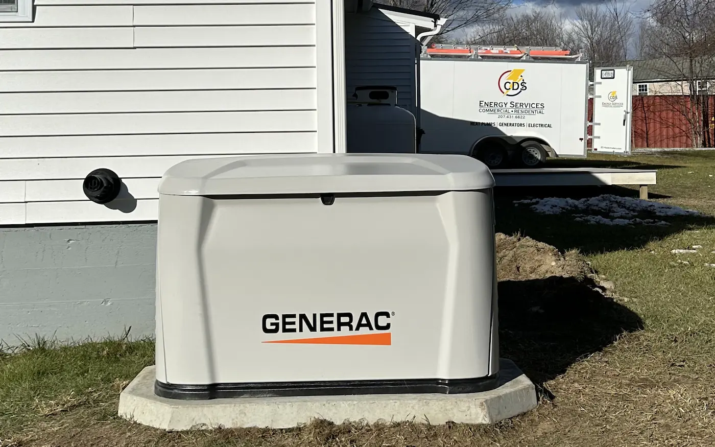 Generac standby generator installed next to a Maine home with automatic transfer switch