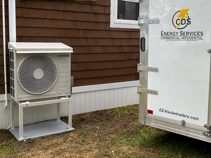 Ductless heat pump outdoor unit installed on Maine home exterior