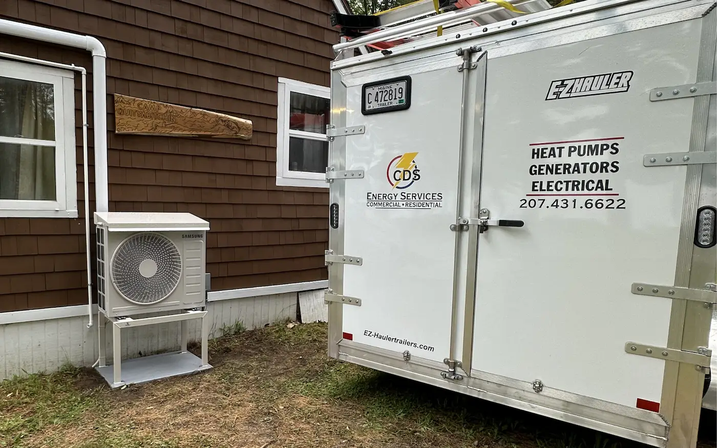 Ductless heat pump outdoor unit installed on Maine home exterior