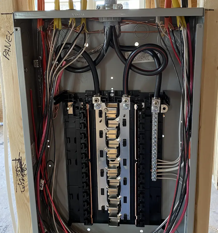CDS Energy Services — Licensed electrician Dereck Shaw installing a 200-amp electrical panel in Maine